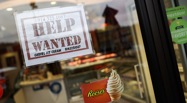 A help wanted sign in a storefront in Bedford, N.Y.