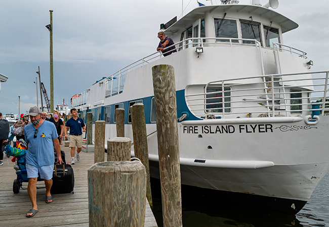 People disembark from a ferry in Bay Shore, N.Y., as it arrived from Fire Island.