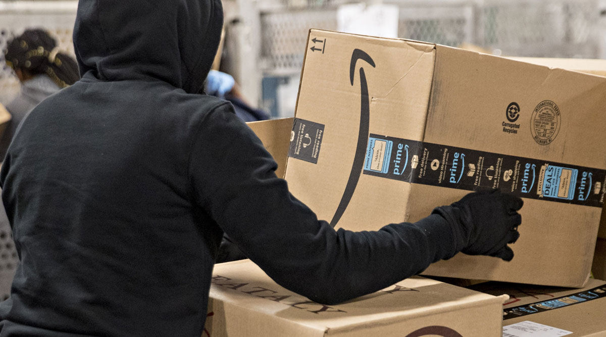 A USPS employee moves an Amazon.com Inc. package at a processing and distribution center in Washington in December 2017.