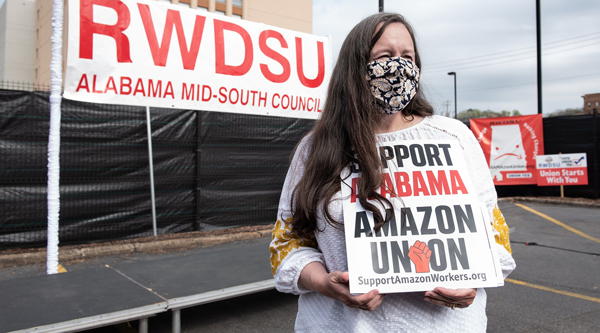 An RWDSU supporter holds a sign outside of union headquarters in Birmingham, Ala.