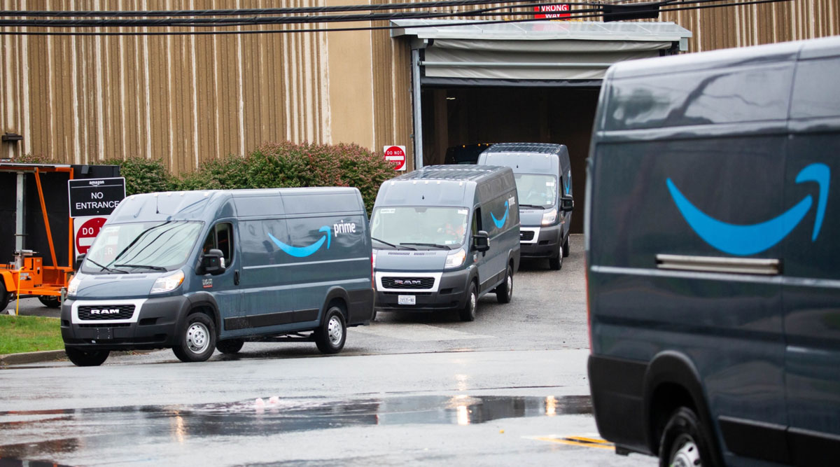 Vans leave an Amazon delivery station in Carlstadt, N.J. (Michael Nagle/Bloomberg News)