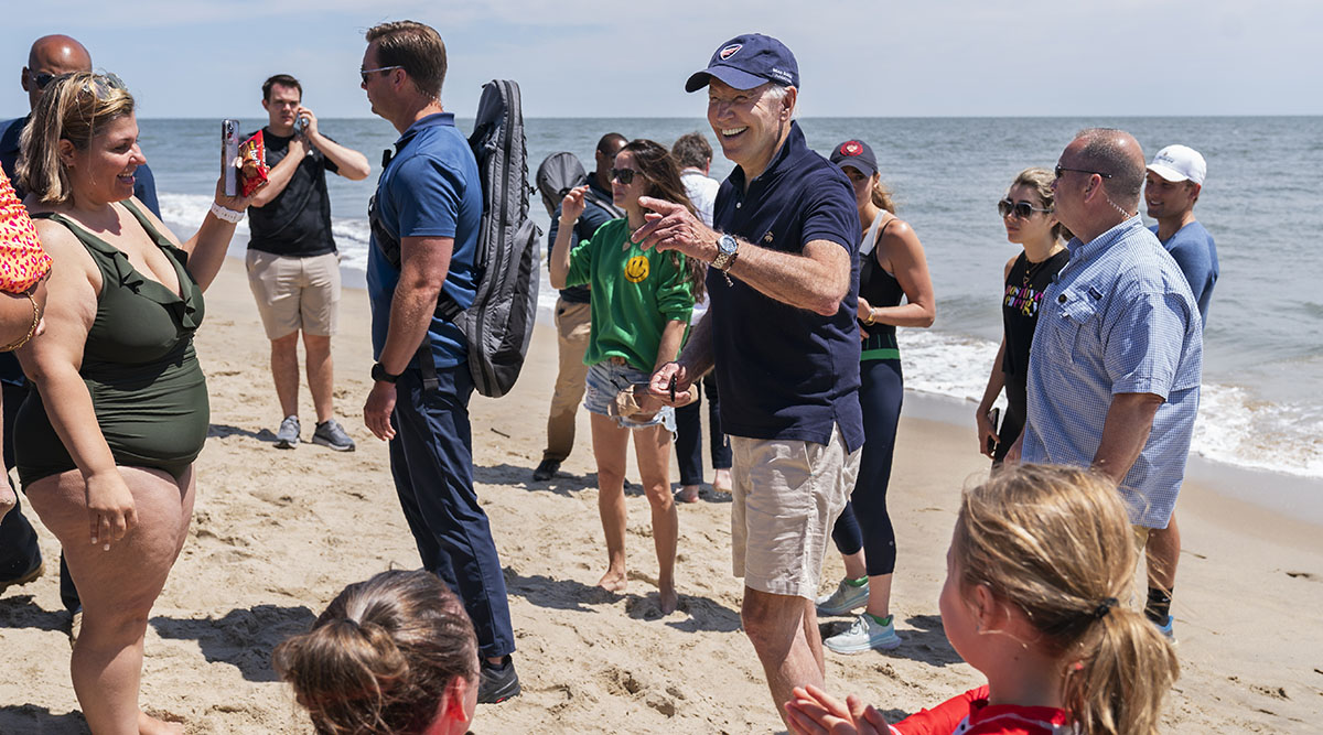 President Joe Biden talks to beachgoers 