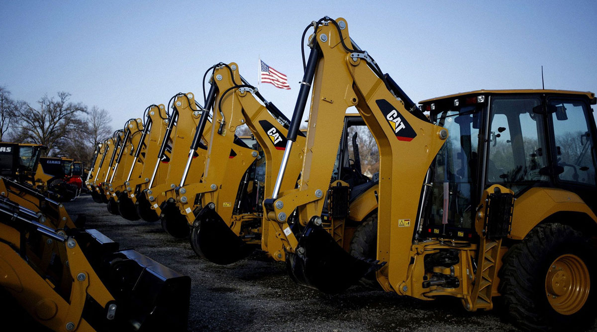 Caterpillar backhoe excavators are displayed for sale at a dealership in Louisville, Ky.