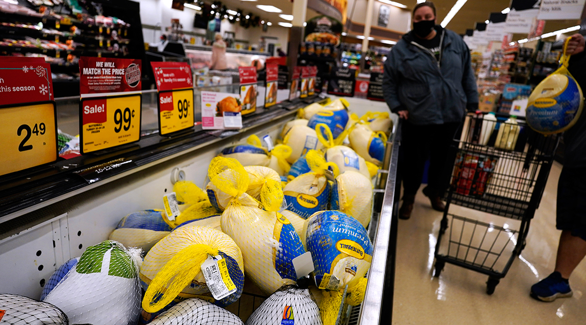 Customers shop for frozen turkeys for Thanksgiving dinner at a grocery store in Mount Prospect, Ill.