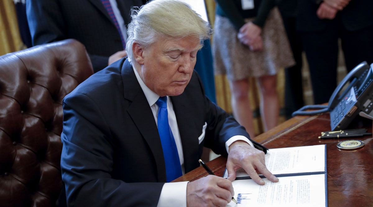 President Trump signs one of five executive orders related to the oil pipeline industry in 2017.