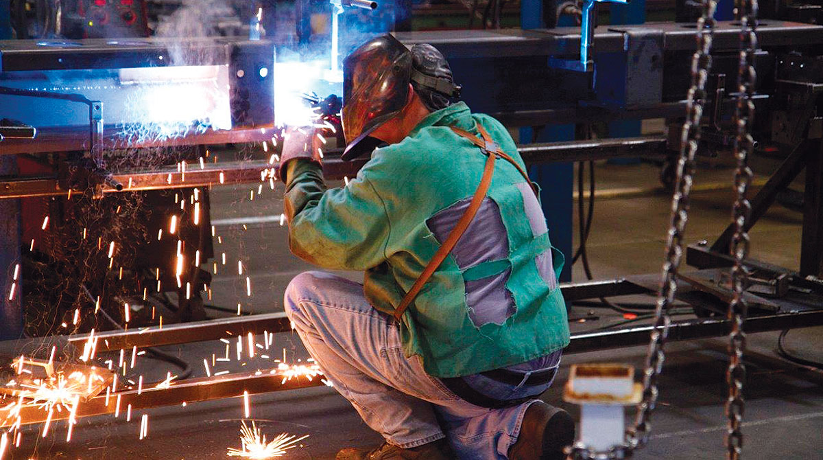 A worker prepares parts at a Stoughton Trailers plant in Stoughton, Wis.