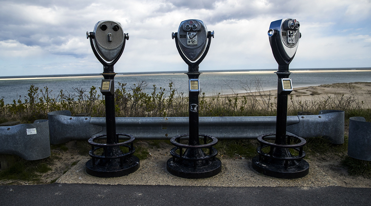 Binoculars stand near the Chatham lighthouse on Cape Cod in Chatham, Mass.