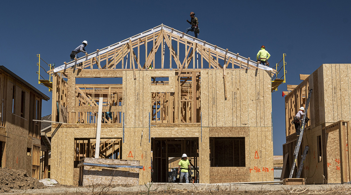 Contractors work on a home under construction in Antioch, Calif.