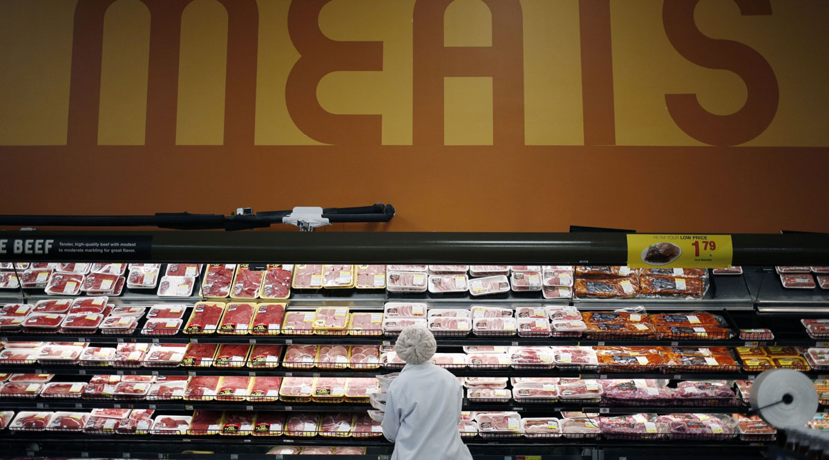 An employee restocks shelves in the meat section at a Kroger Co. supermarket in Louisville, Ky.