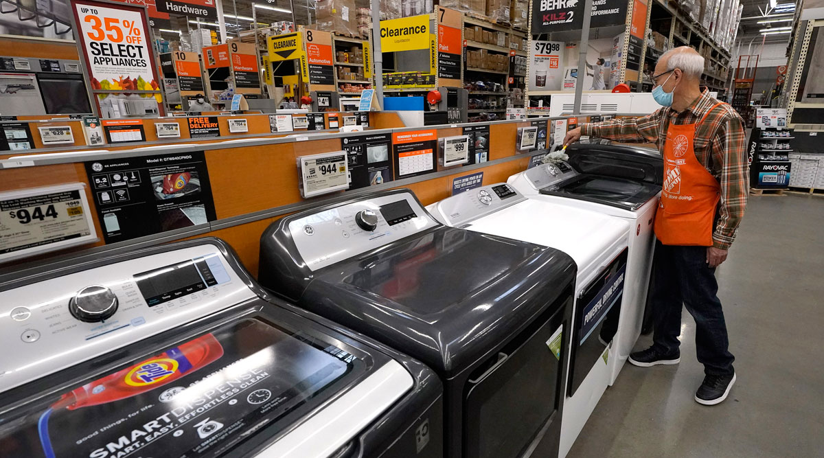 Javad Memarzadeh dusts washers on display in a Home Depot location in Boston on Oct. 29.