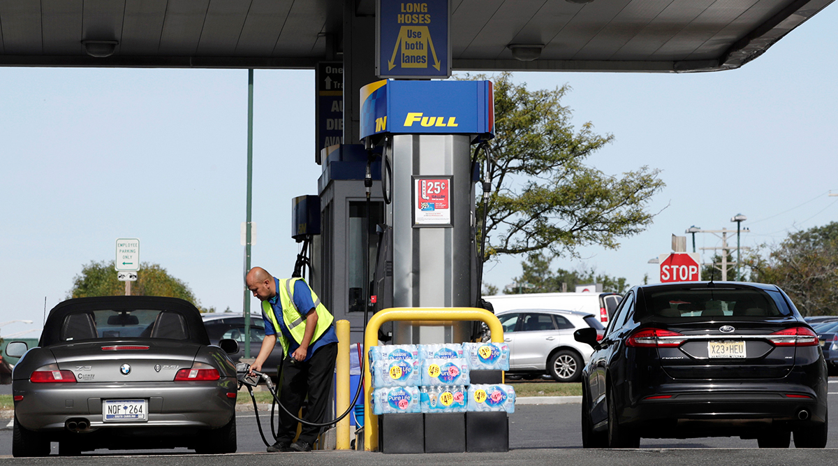 A Sunoco employee fills a vehicle with gas at the Cheesequake Rest Area in South Amboy, N.J.