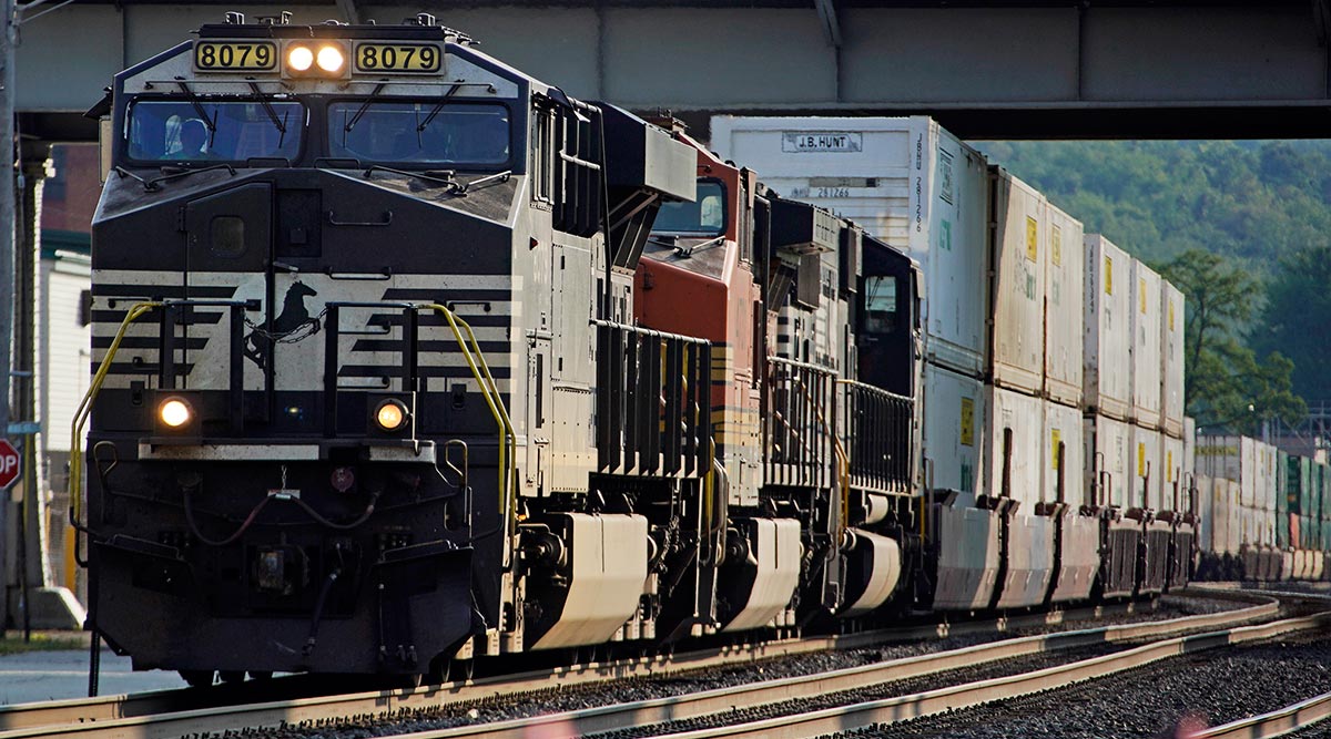 A Norfolk Southern freight train runs through a crossing in Homestead, Pa.