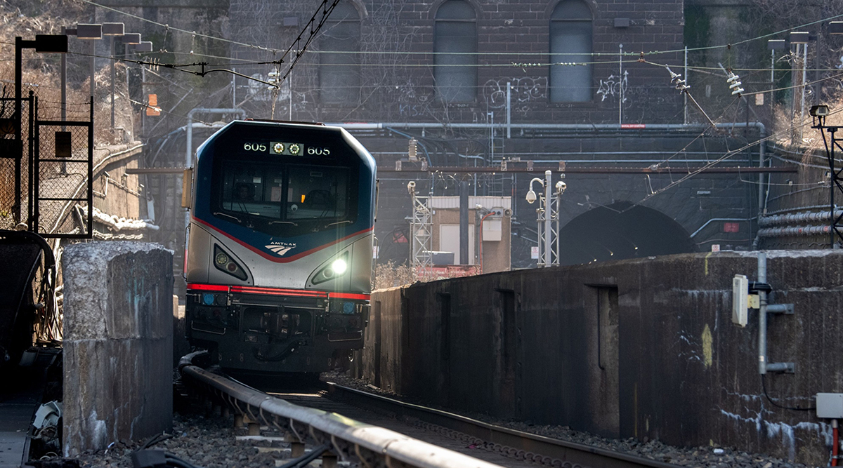 An Amtrak train exits the North River Tunnel in North Bergen, N.J.