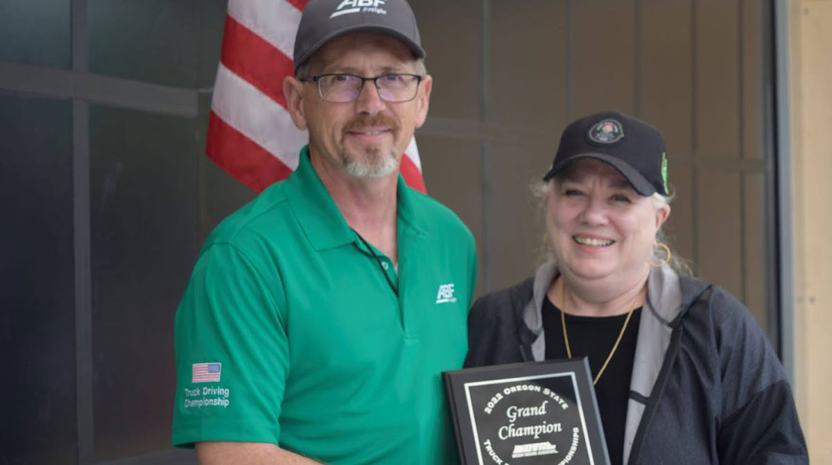 2022 Oregon grand champion Tim Melody with Oregon Trucking Associations President Jana Jarvis