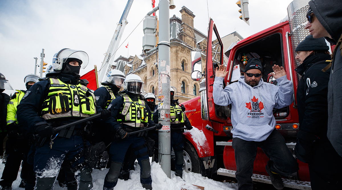 A man steps out of truck as police move in to clear downtown Ottawa Feb. 19.