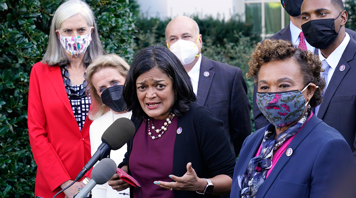 Rep. Pramila Jayapal (D-Wash.), the chair of the Congressional Progressive Caucus, surrounded by other lawmakers.