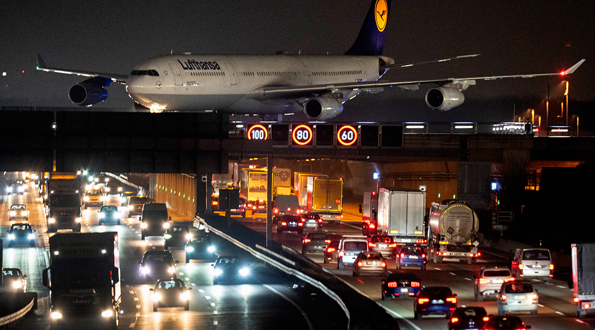 an aircraft crossing a bridge over a highway at the airport in Frankfurt, Germany