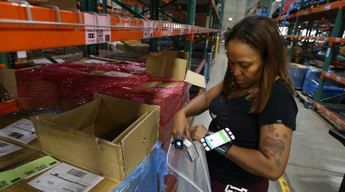 Syrina Franklin, an order fulfillment associate at ShipBob, picks products for an order.