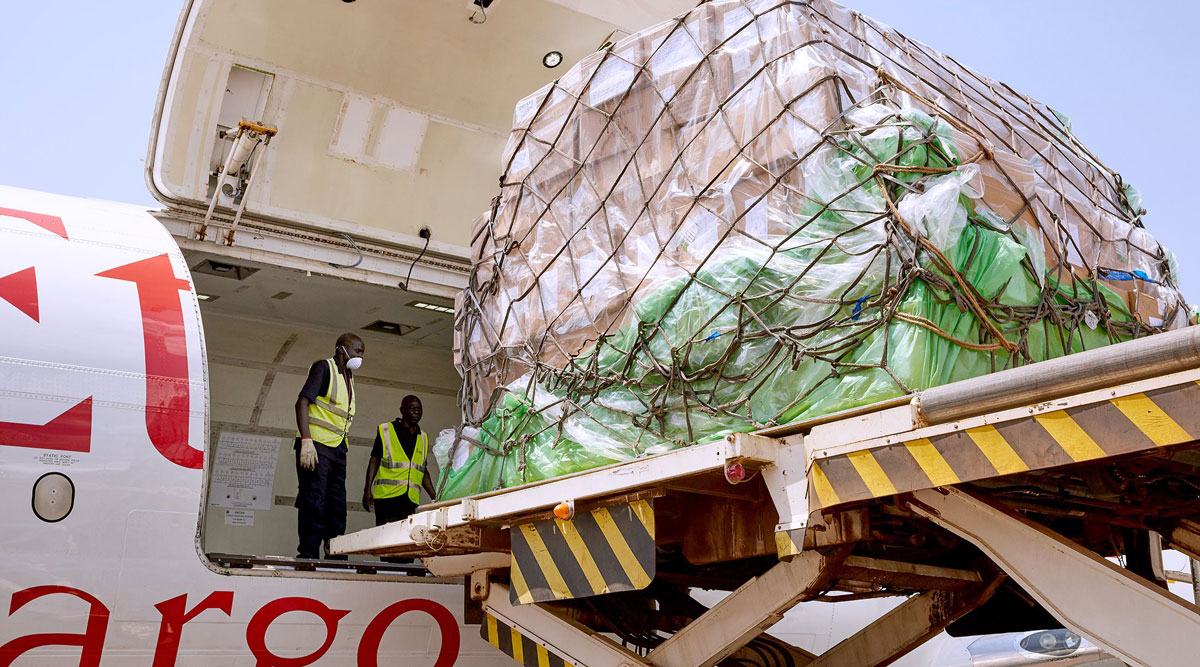 Airport staff unload cargo after it arrives at Juba International Airport in Sudan on March 24.