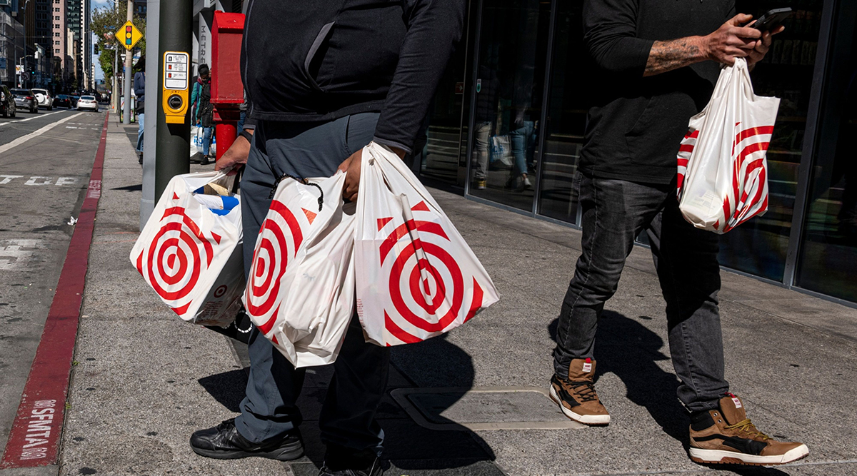 Shoppers carry Target shopping bags in front of a store in San Francisco