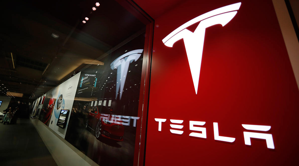 A sign bearing the company logo outside a Tesla store in Cherry Creek Mall in Denver