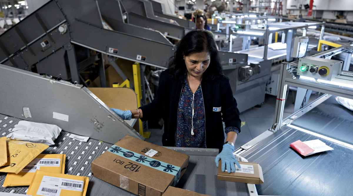 A worker sorts packages at the USPS Merrifield process and distribution center in Merrifield, Va., in December 2018.