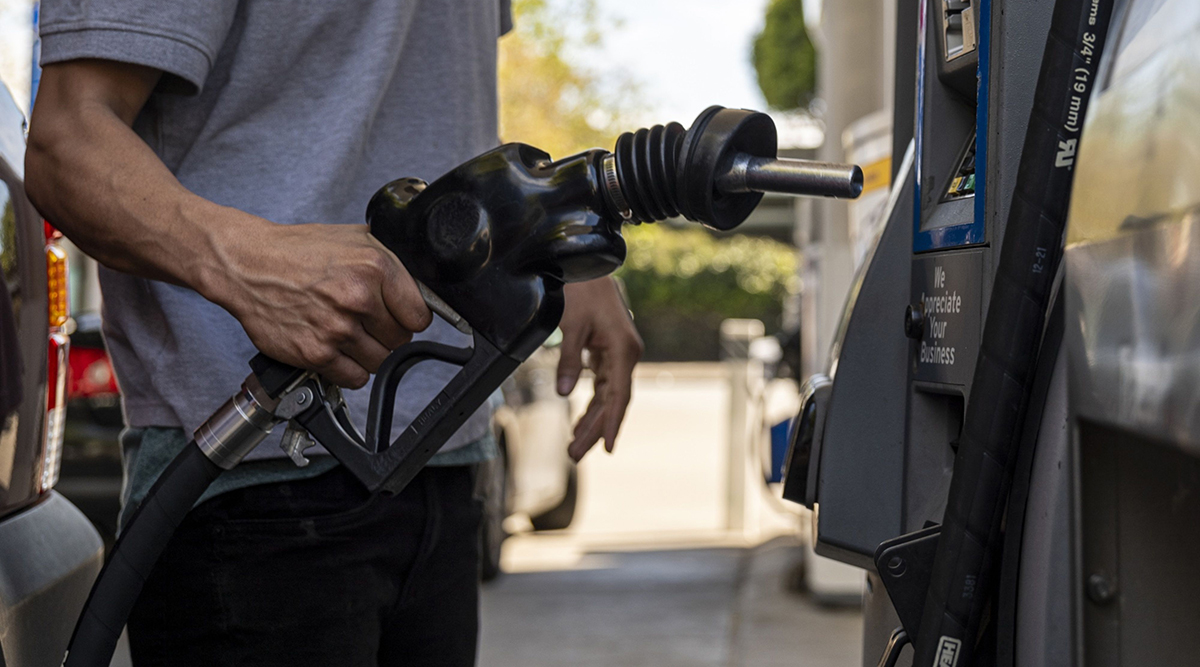 A driver returns a fuel nozzle to a gas pump at a Chevron gas station in San Francisco.