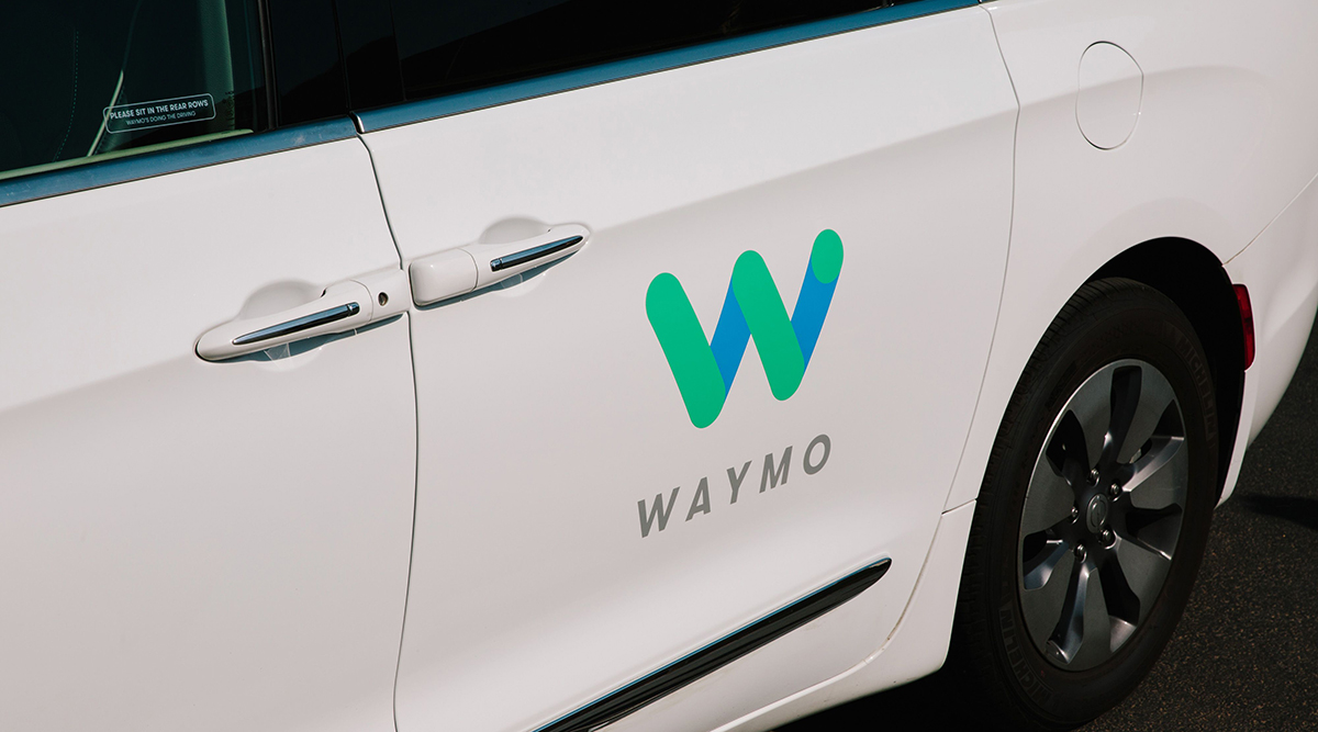 Waymo signage on the door of a Chrysler Pacifica autonomous vehicle