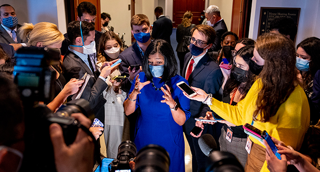 Rep. Pramila Jayapal speaks to reporters as she walks out of a House Democratic Progressive Caucus meeting