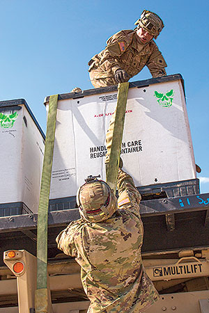 National Guardsmen tie down a load