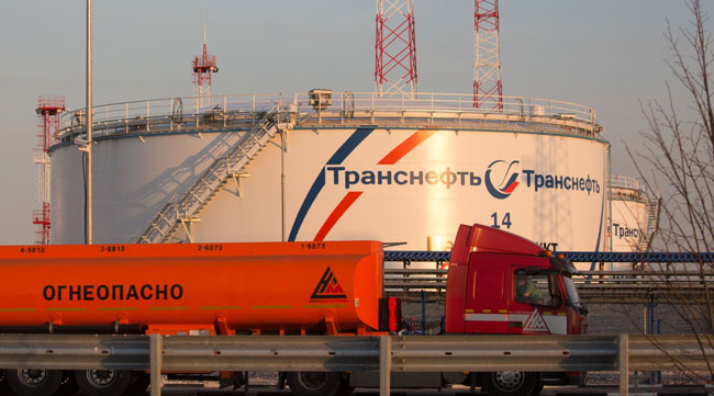 A gas tanker drives past oil storage tanks at a dispatcher station in a village near Moscow, Russia, on April 7.