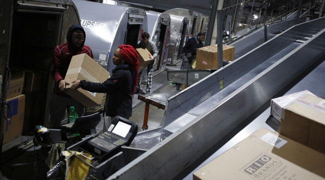 Employees load packages into a shipping container at a UPS Worldport facility in Louisville, Ky., on Jan. 28.