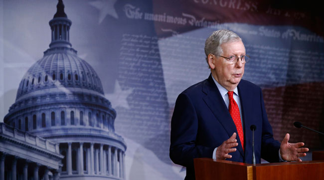 Senate Majority Leader Mitch McConnell speaks with reporters on Capitol Hill April 21.