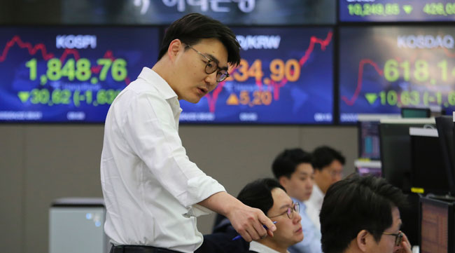A currency trader gestures at the foreign exchange dealing room of the KEB Hana Bank headquarters in Seoul, South Korea, on April 22.
