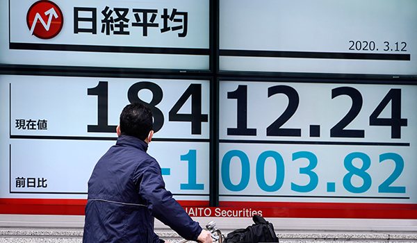 Man watches Japan's Nikkei 225 index