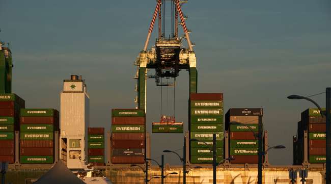 A gantry crane moves a shipping container
