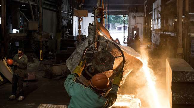 Molten steel is poured into a large mold at a castings facility