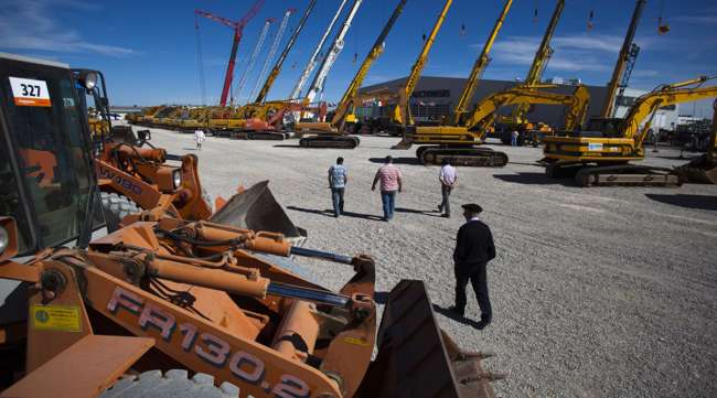 Customers at a Ritchie Bros. auction for heavy construction equipment