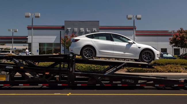 A Tesla Model 3 vehicle on an auto carrier