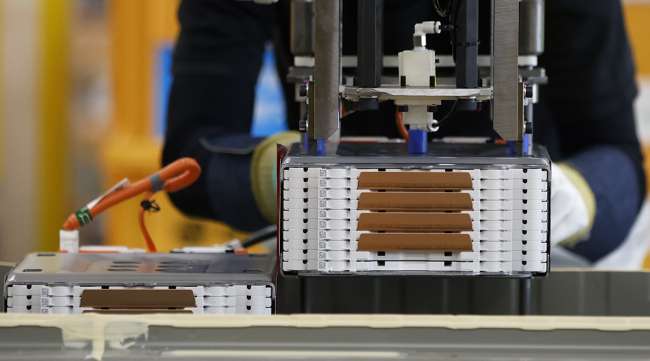 A stack of lithium-ion batteries are installed onto a battery pack