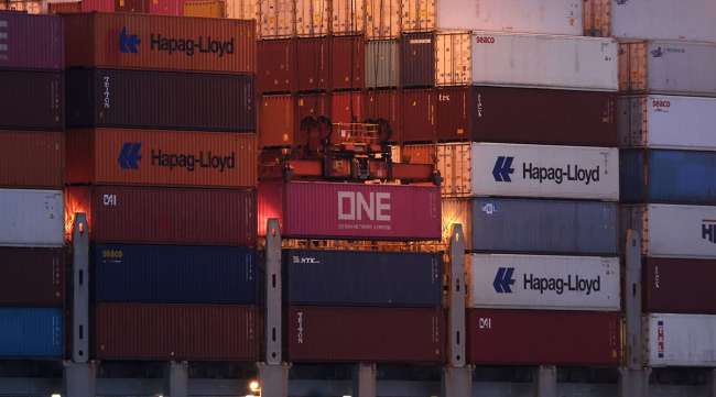 A crane loads an Ocean Network Express container onto the Valiant container ship