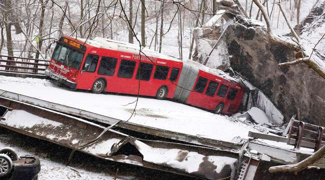 A Pittsburgh Transit Authority bus on the collapsed Fern Hollow Bridge