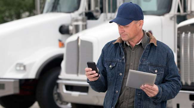 Truck driver on phone, tablet