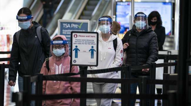 Travelers wear face masks and shields at Reagan National Airport on Nov. 25.