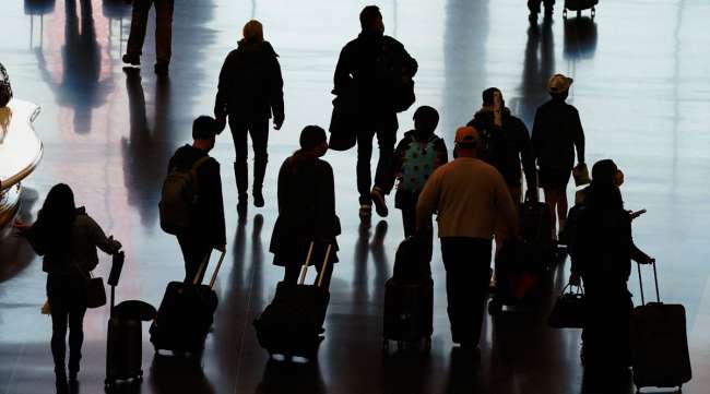 Travelers walk through the Salt Lake City International Airport on Nov. 25. (Rick Bowmer/Associated Press)
