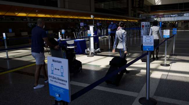 Passengers walk past thermal imaging cameras at Los Angeles International Airport.