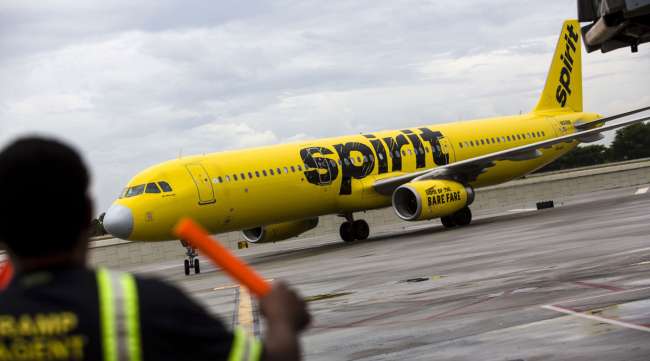 An aircraft marshal guides a Spirit Airlines plane on the tarmac at Fort Lauderdale International Airport in 2017.