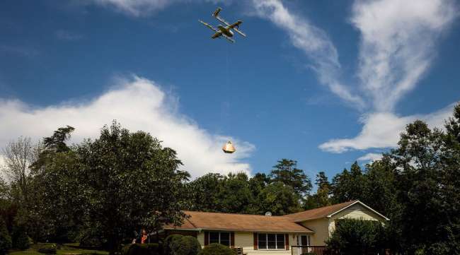An Alphabet Wing drone delivers a package at home during a demonstration in Blacksburg, Va., in 2018.