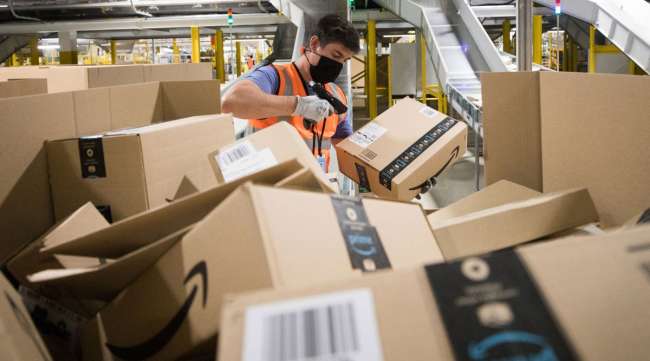 An employee scans a package at an Amazon fulfillment center in the U.K.