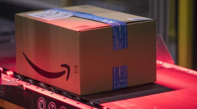A packed box moves along an Amazon conveyor belt in Tilbury, U.K.